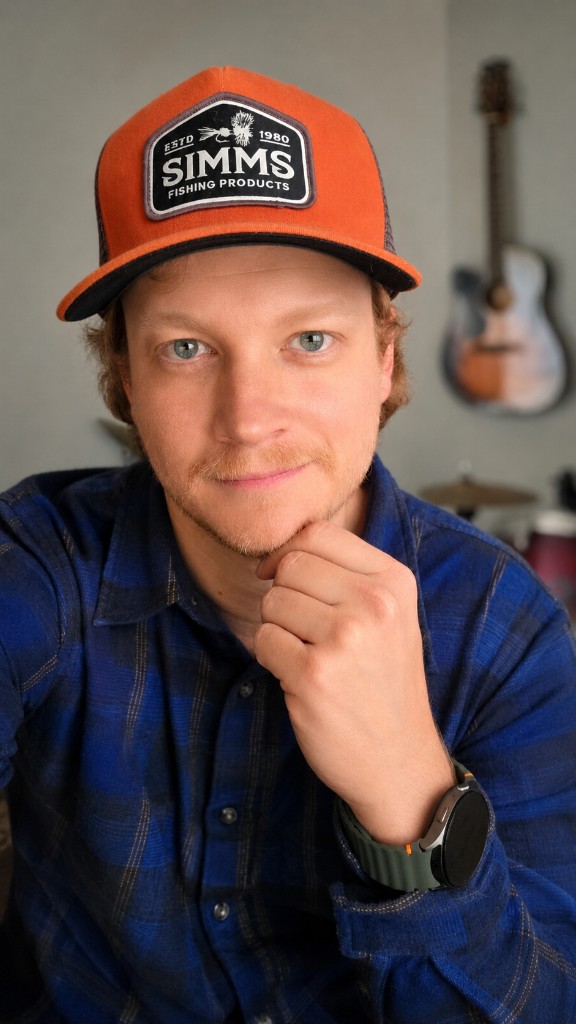 Luke Libby wearing an orange cap and plaid shirt